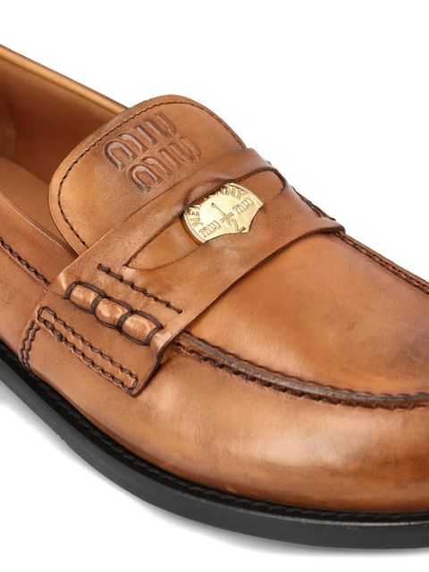 Miu Miu embossed applique loafers - Brown